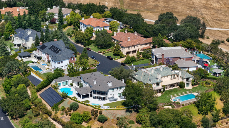Aerial view of large houses with backyard pools