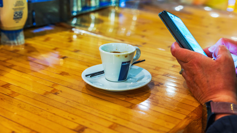 A guest drinking a Lavazza espresso