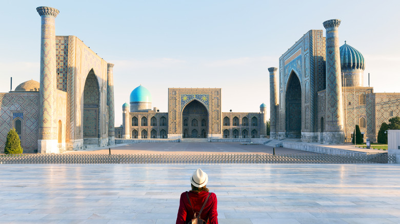 A woman in red in Registan Square in Samarkand, Uzbekistan