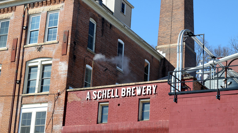 Red and brown brick building, marked 'A Schell Brewery' in large white letters