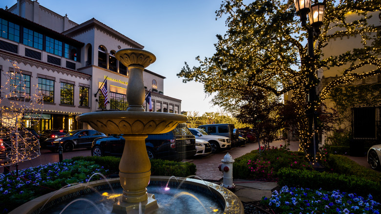 A fountain framing stores at Highland Park Village.