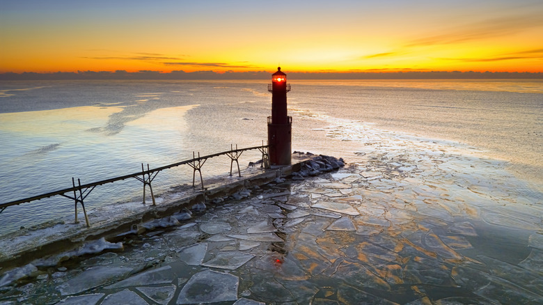 Amazing icy scenic harbor with lighthouse, Lake Michigan in Winter