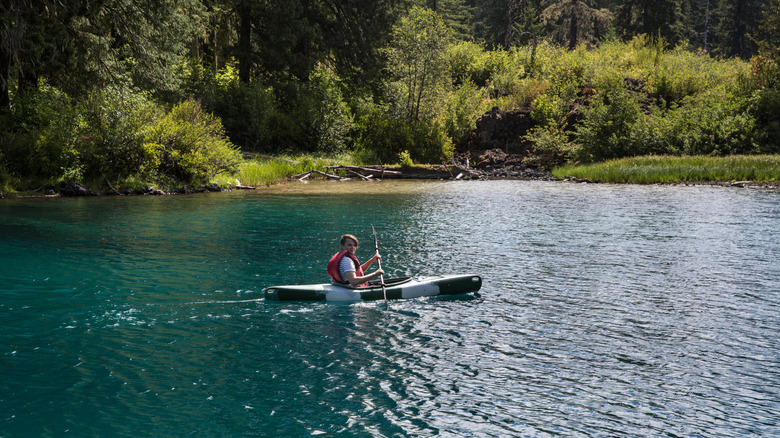 A kayaker glides across the water on Clear Lake, Oregon.