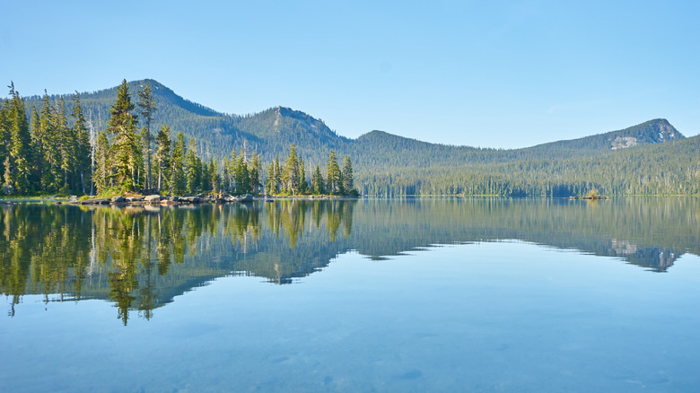 Mountains reflecting on Waldo Lake in oregon.