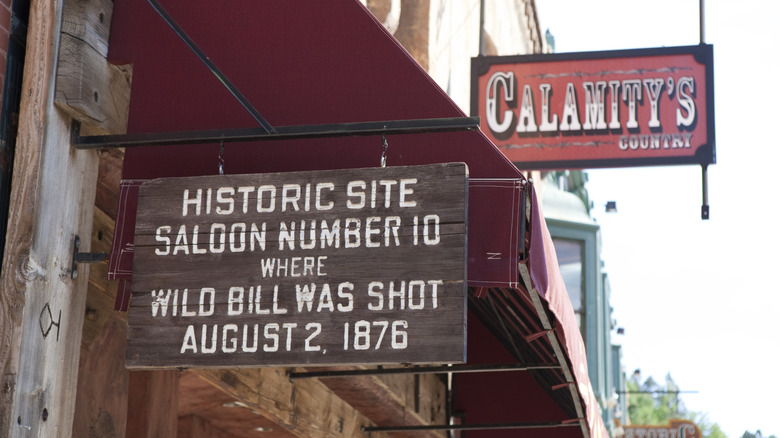 Wooden sign advertises historic saloon in Deadwood