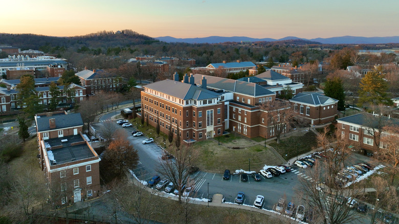 An aerial view of sunset over the University of Virginia in Charlottesville with mountains in the background