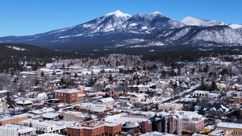 An aerial view of Flagstaff, Arizona, in the winter with the San Francisco Peaks in the background