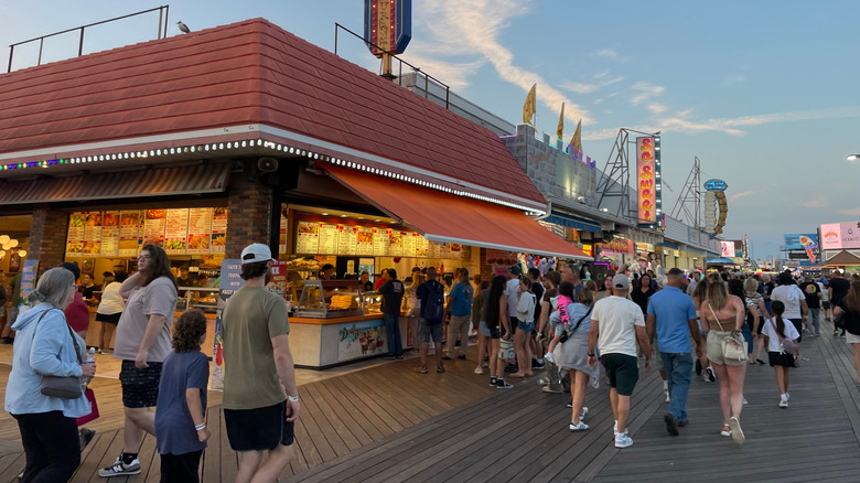 Visitors walking down Wildwoods' boardwalk