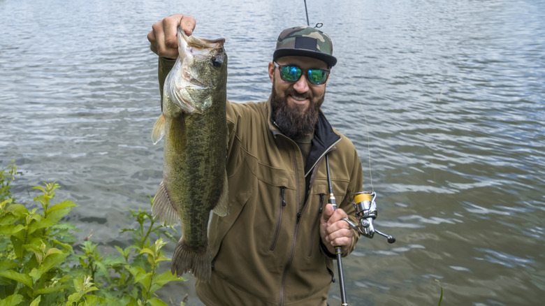 An angler holds up a trophy largermouth bass