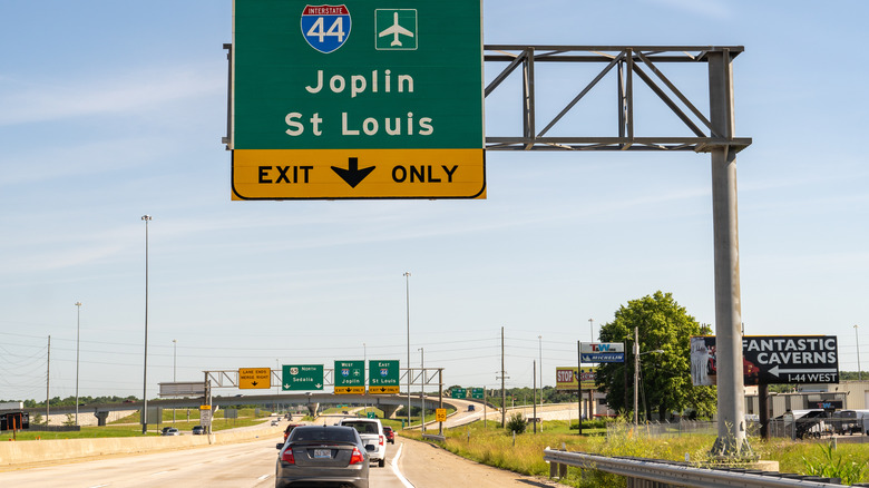 Cars drive Interstate 44 under a sign for Joplin and St Louis