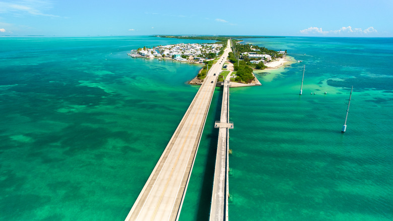 A highway crosses a blue-green sea to one of the Florida Keys