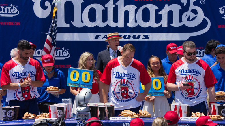 Nathans Famous Hot Dog Eating Contest at Coney Island sees Joey Chestnut and Miki Sudo compete amid a festive Surf Avenue crowd