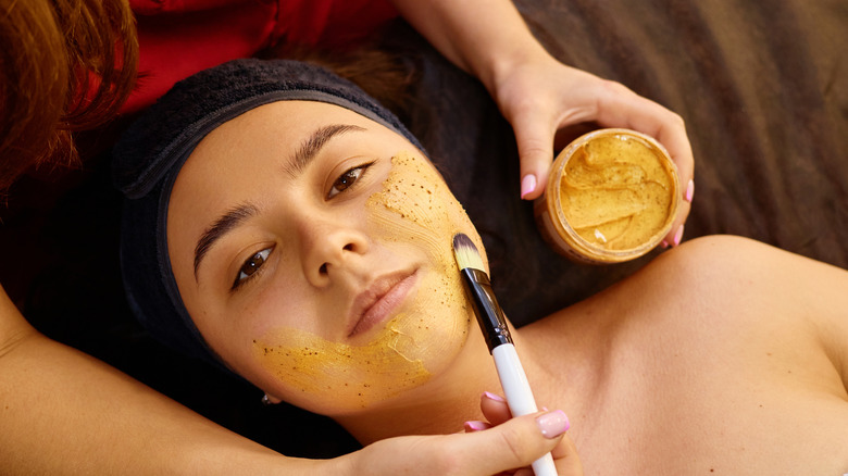 A woman getting a facial using honey