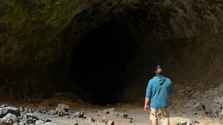 A visitor looking into Derrick Cave