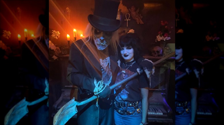 A ghoulish costumed character and guest in haunted house