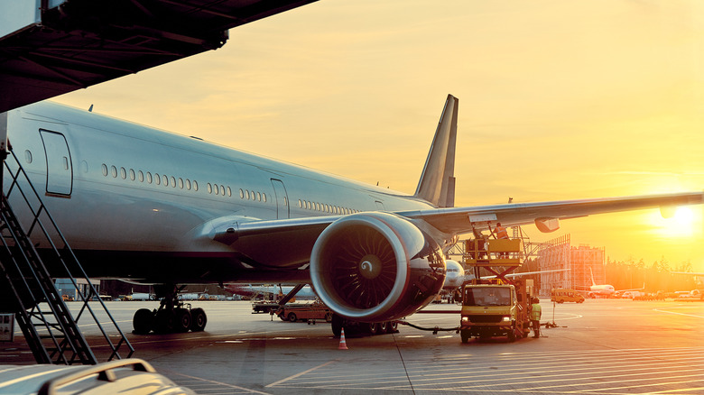 An airline on the runway at sunrise