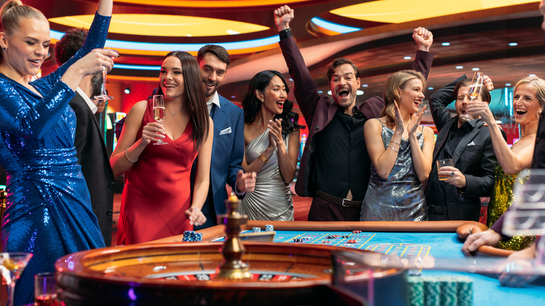 People having fun with a roulette game in a casino