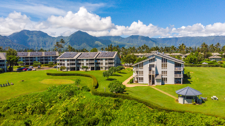 The Cliffs at Princeville hotel with mountains in background on Kauai