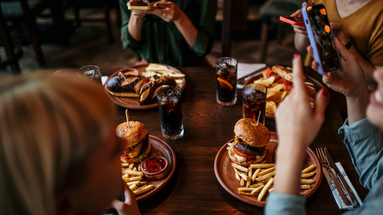 People eating burgers at a restaurant