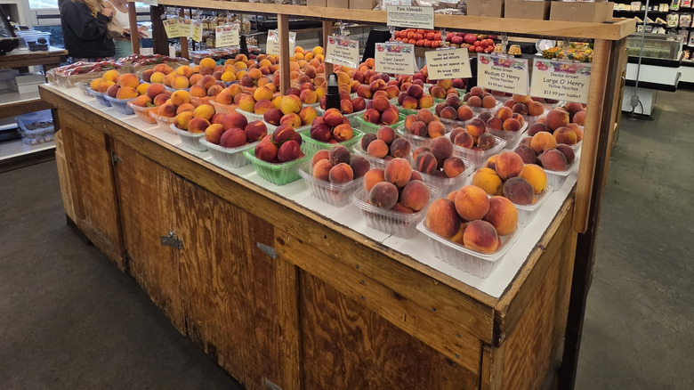 A display of fresh peaches for sale from the orchard at Ikeda's Country Market in Auburn, California