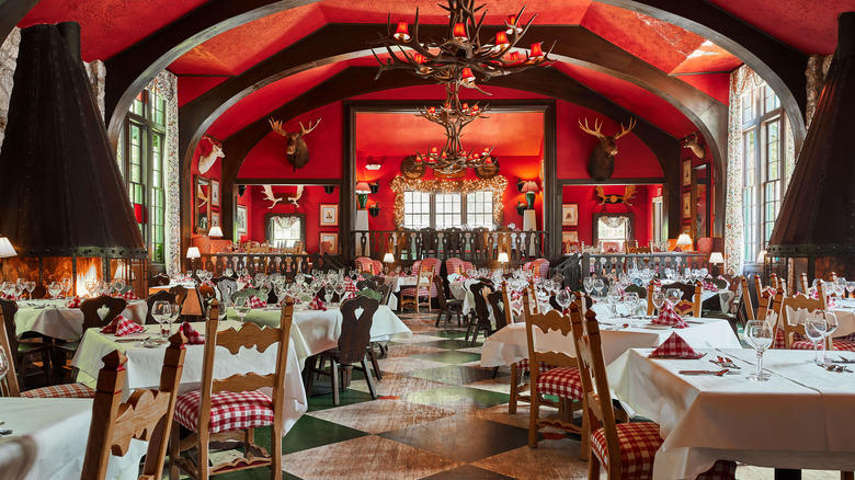 Interior view of the deep red and elegant interior of Woods Restaurant, a Bavarian-themed restaurant belonging to Grand Hotel on Mackinac Island, a car-free island in Lake Huron, Michigan, U.S.A.