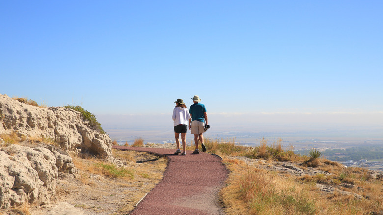 Couple walking along path on open hilltop in Nebraska