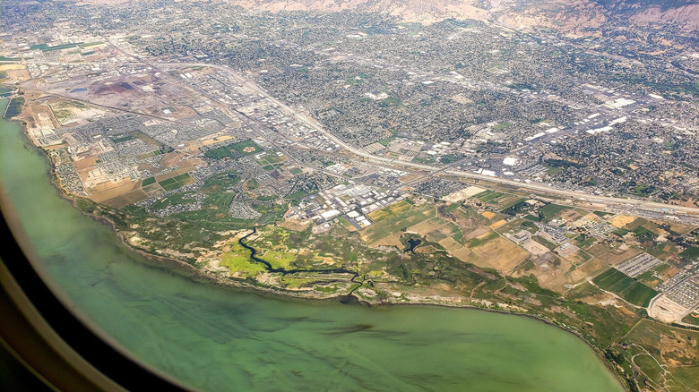 View of Provo and Utah Lake from an airplane window flying high above the city.