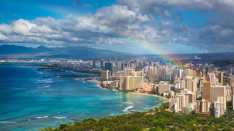 An aerial view of Honolulu with a rainbow