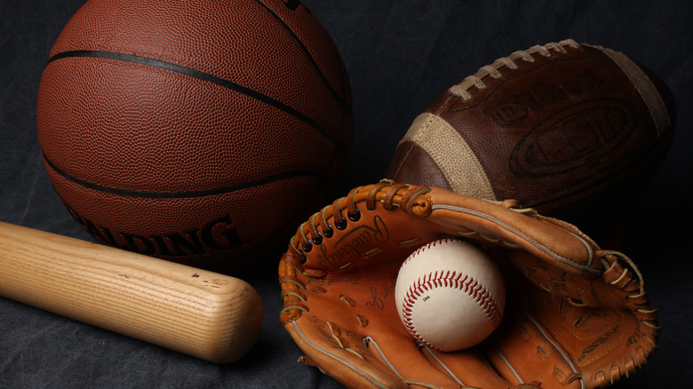 A basketball, football, and baseball glove and bat