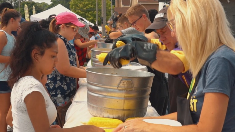 attendeess lined up for corn at the Mendota Sweet Corn Festival