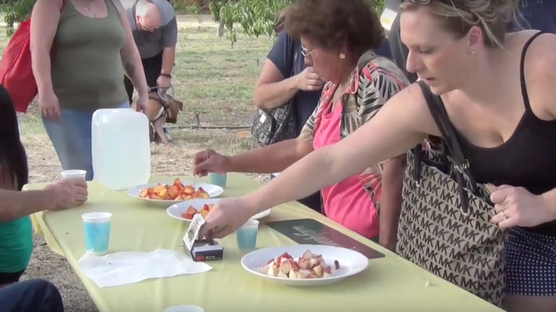 Attendees trying fruit samples at the Organic Stone Fruit Jubilee