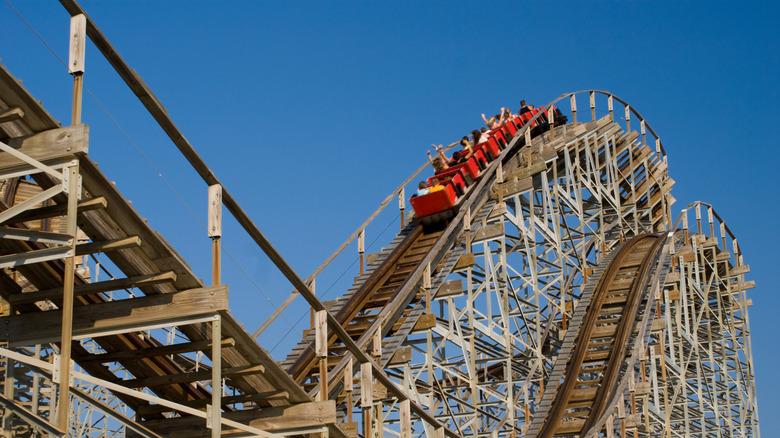 Car climbing a wooden roller coaster