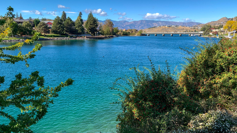 Blue waters surrounded by forests and hills in Lake Chelan, WA