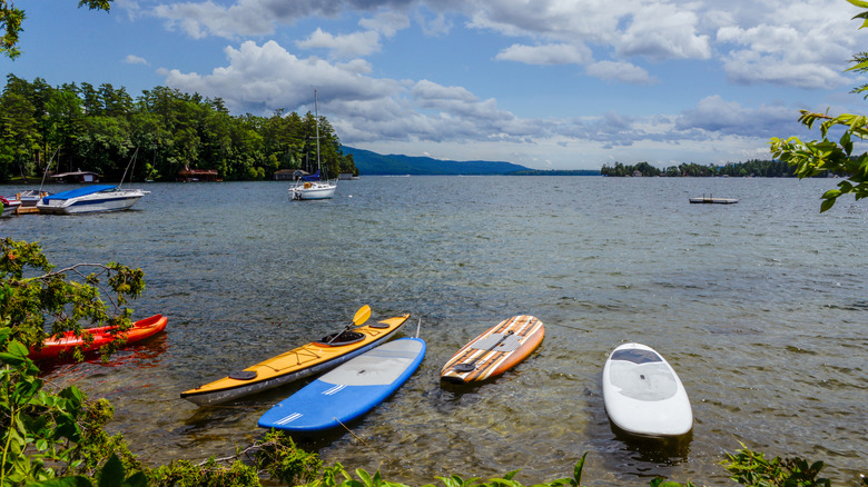 Stand up paddleboards sit on the shores of Lake George, New York