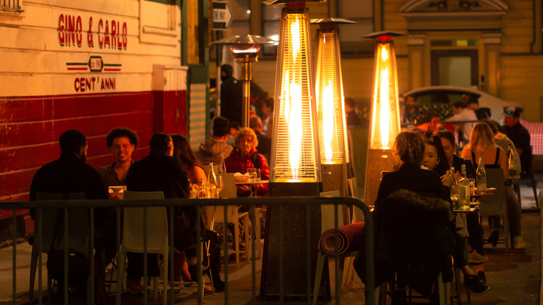 People dining outside under dim lights in San Francisco