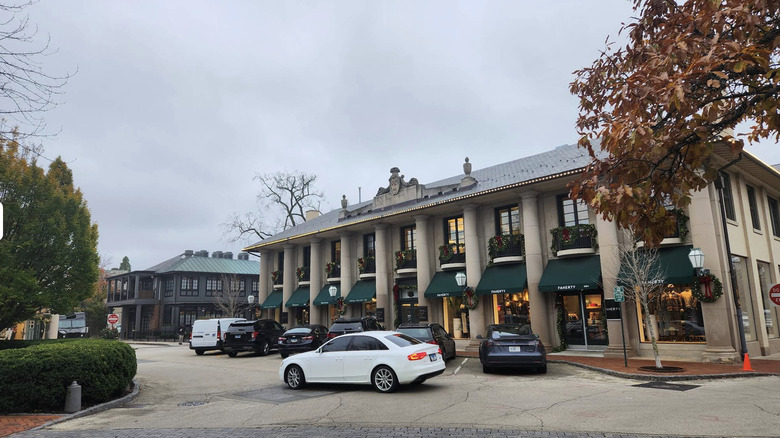 Store with columns and elaborate stone facade with cars in front of Market Square, Illinois