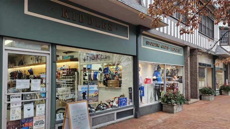 Kiddles Sporting Goods sign with display window and brick sidewalk