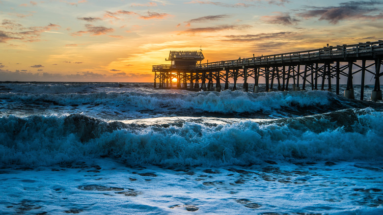 Pier going into water with sunrise in Florida