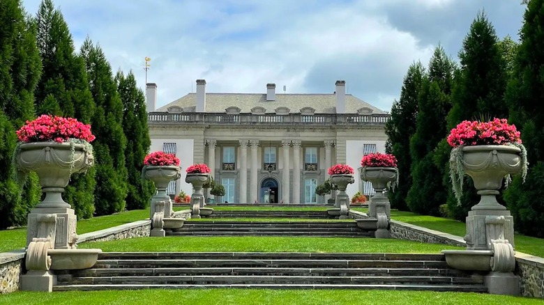 The exterior of Nemours Estate with vibrant pink flowers