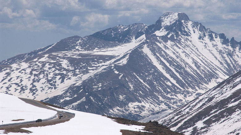 Cars driving the snowy Trail Ridge Road in Colorado's snowy Rocky mountains