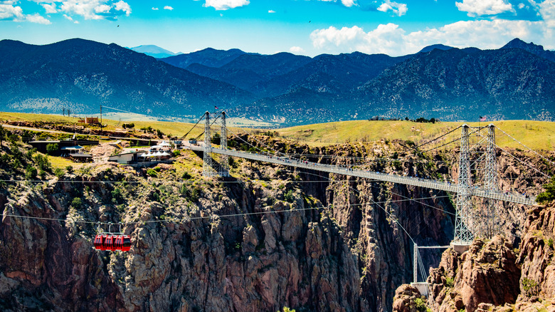 The Royal Gorge Bridge in Colorado with red gondolas above