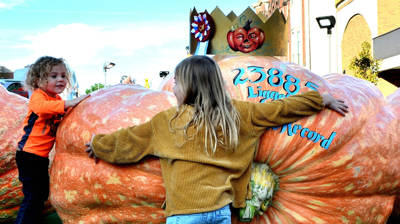 Children with giant pumpkins