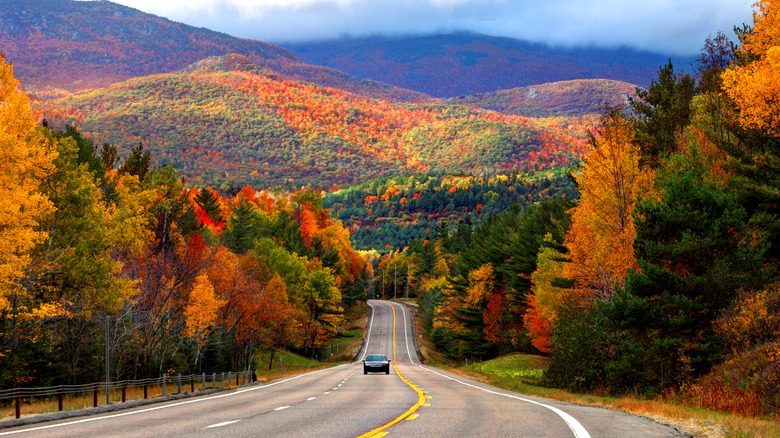 Car driving through the fall foliage in the Adirondack Mountains