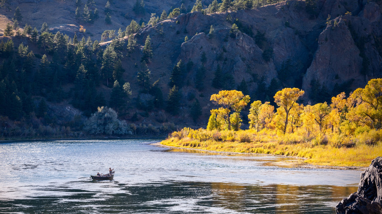 Two fishermen in a drift boat on the Missouri River in Montana during the autumn