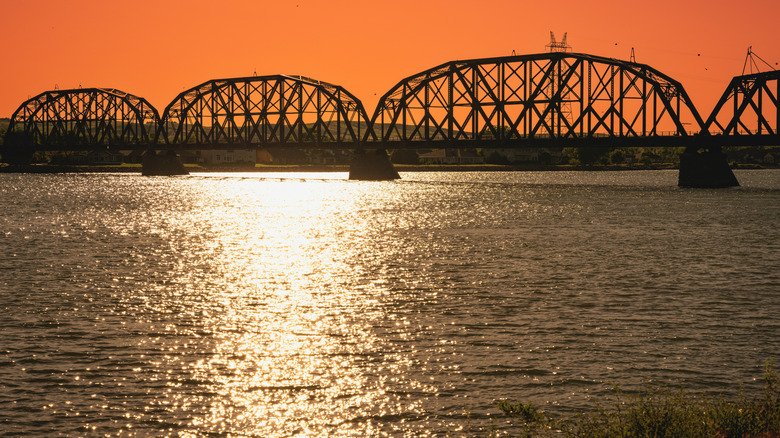 Old bridge crossing the Missouri River in North Dakota, at sunset