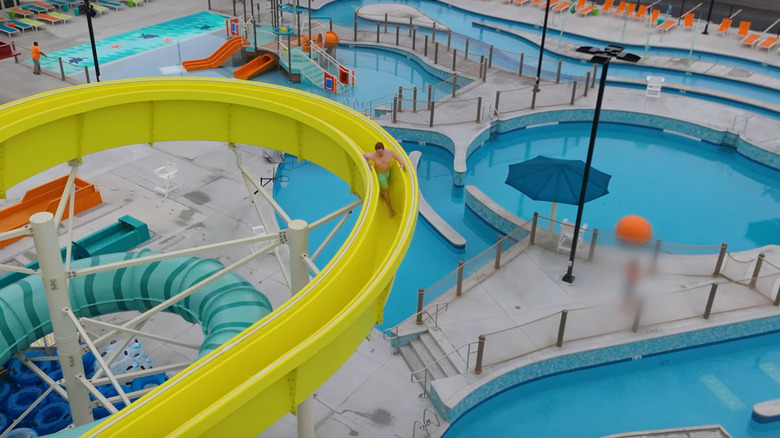 Parkgoer sliding down the stand-up water slide
