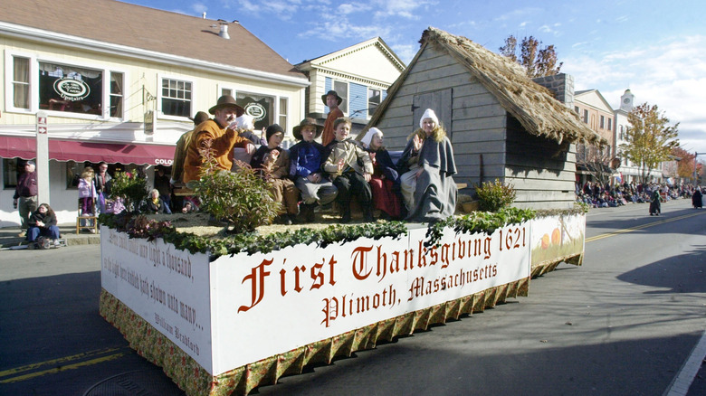 Plymouth locals dressed as Pilgrims on float during America's Hometown Thanksgiving Celebration