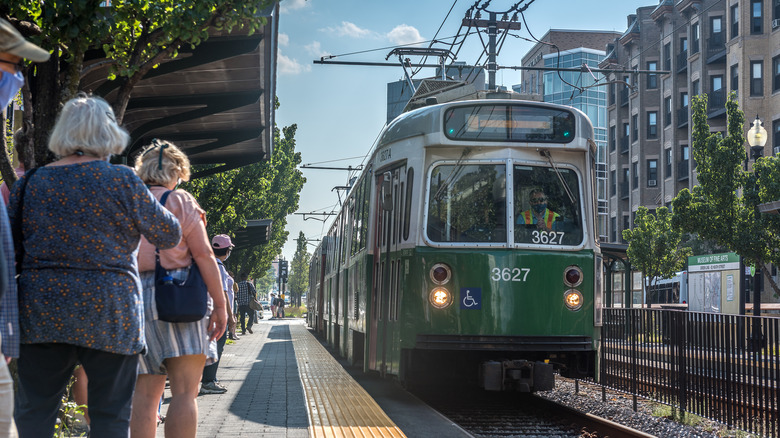 Passengers wait on a platform for an arriving Green Line car in Boston, Massachusetts