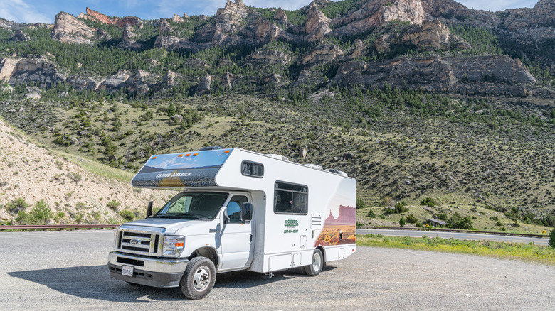 An RV parked in front of rugged mountain scenery in South Dakota