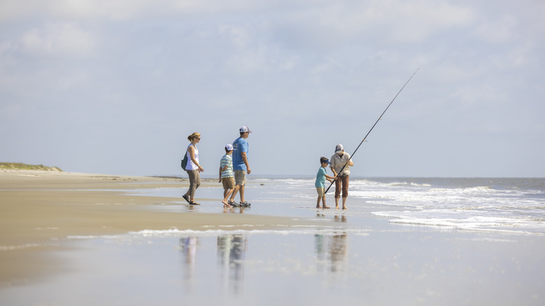 people fishing on the beach